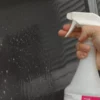 RapidTAC 946ml spray bottle with trigger and the application fluid for signmakers having been sprayed onto the substrate ready for cleaning / wet application of the application surface prior to applying a self-adhesive vinyl.