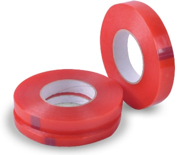 Three different sizes of DSC-2065F clear double-sided high tack sign tape shown in their reeled rolls, two of the reel widths are on their side, horizontally stacked on top of each other, and the third reel is offset to the side standing upright on it's short edge.