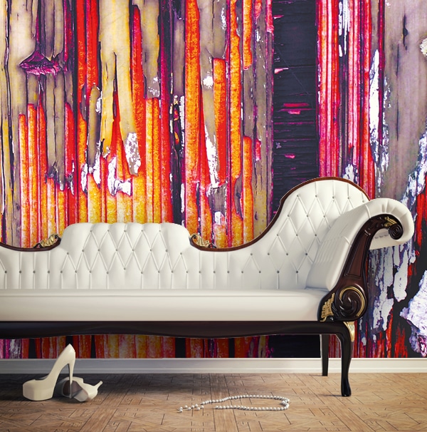 Avery Dennison MPI 8520 smooth silky graphics wallpaper shown with a custom printed image in a living room with the coach in front. The wall design is a warm red, yellow and black distressed wood pattern with paint cracking off revealing bare wood in places.
