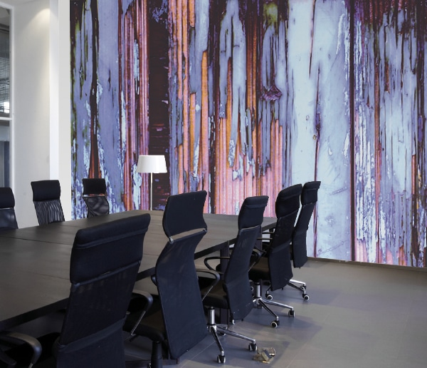 Avery Dennison MPI 8024 smooth custom printed wallpaper decorating a conference room wall printed with a wooden planks design with peeling purple and lilac coloured distressed paintwork.