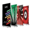 Altona Two pull-up graphic display stands, 4 different printed roll-up designs lined up in a row and standing up straight with no curl, one stand in front of the other.