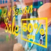 Avery 200 EF self-adhesive bright yellow cut-vinyl signage text, stuck on a retail window advertising an "end of season sale with 50% off".