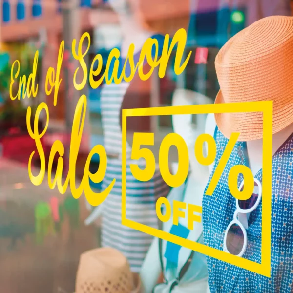 Avery 200 EF self-adhesive bright yellow cut-vinyl signage text, stuck on a retail window advertising an "end of season sale with 50% off".