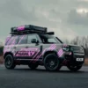 Coloured cut-vinyl graphics using Avery Dennsion self-adhseive marking film 900 SC Shocking Pink colour film applied to a black Sports Utility Vehicle for corporate vehcile branging graphics.