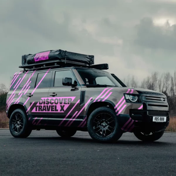 Coloured cut-vinyl graphics using Avery Dennsion self-adhseive marking film 900 SC Shocking Pink colour film applied to a black Sports Utility Vehicle for corporate vehcile branging graphics.