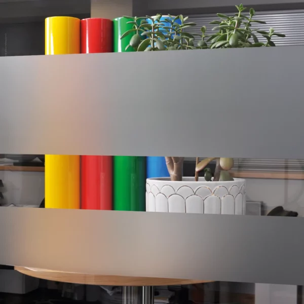 Avery Dusted decorative window film applied to an internal office window in 2 large strips to show the obscurity/privacy levels of this glass etch effect vinyl, with only daylight and vague colours being visible through the areas where the film has been applied.