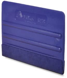 4 inch blue ribbed plastic squeegee with a blue felt covering over one edge and two central ribs for finger grip control and Avery Dennison logo branding on the side.