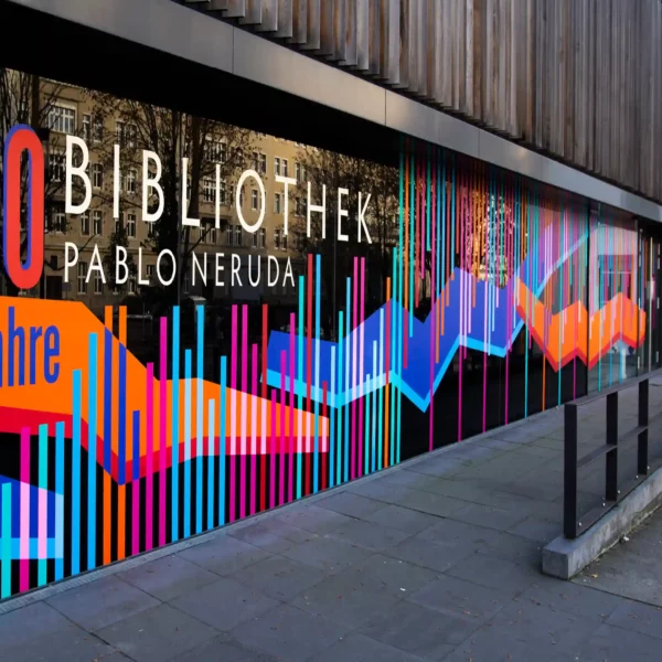 Avery Dennison 700 PF self-adhesive colour vinyls applied in a complimentary choice of orange, magenta, red, white, cyan and deep purple colours that have been cut into stripes and vertically positioned, working as a colourful and modern window graphic display and signage for exterior library windows.