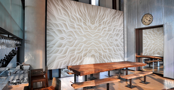 Avery Dennison MPI 8000 Wall Covering Series offers a choice of different finishes for self-adhesive wall design materials, seen here with a printed abstract piece of white and tan coloured wall art decorating an internal cafeteria area.