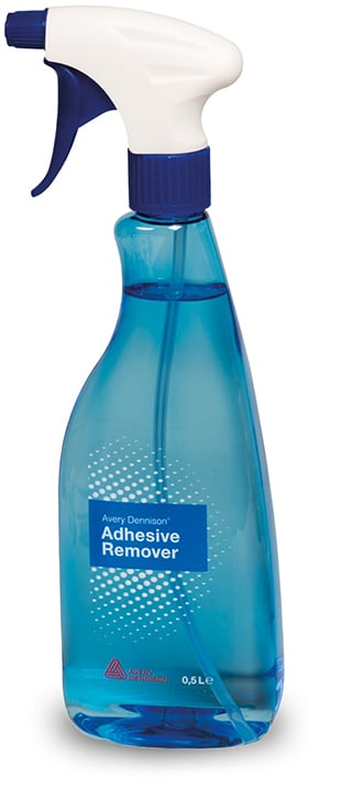Avery Dennisons' Adhesive Remover fluid in it's 500ml, light blue teardrop shaped bottle. The hoto shows a side on view of the teardrop shaped bottle with a slight swan neck grip, complete with adjustable srayer nozzle at the top and blue printed label with Avery Dennison branding facing towards the camera.