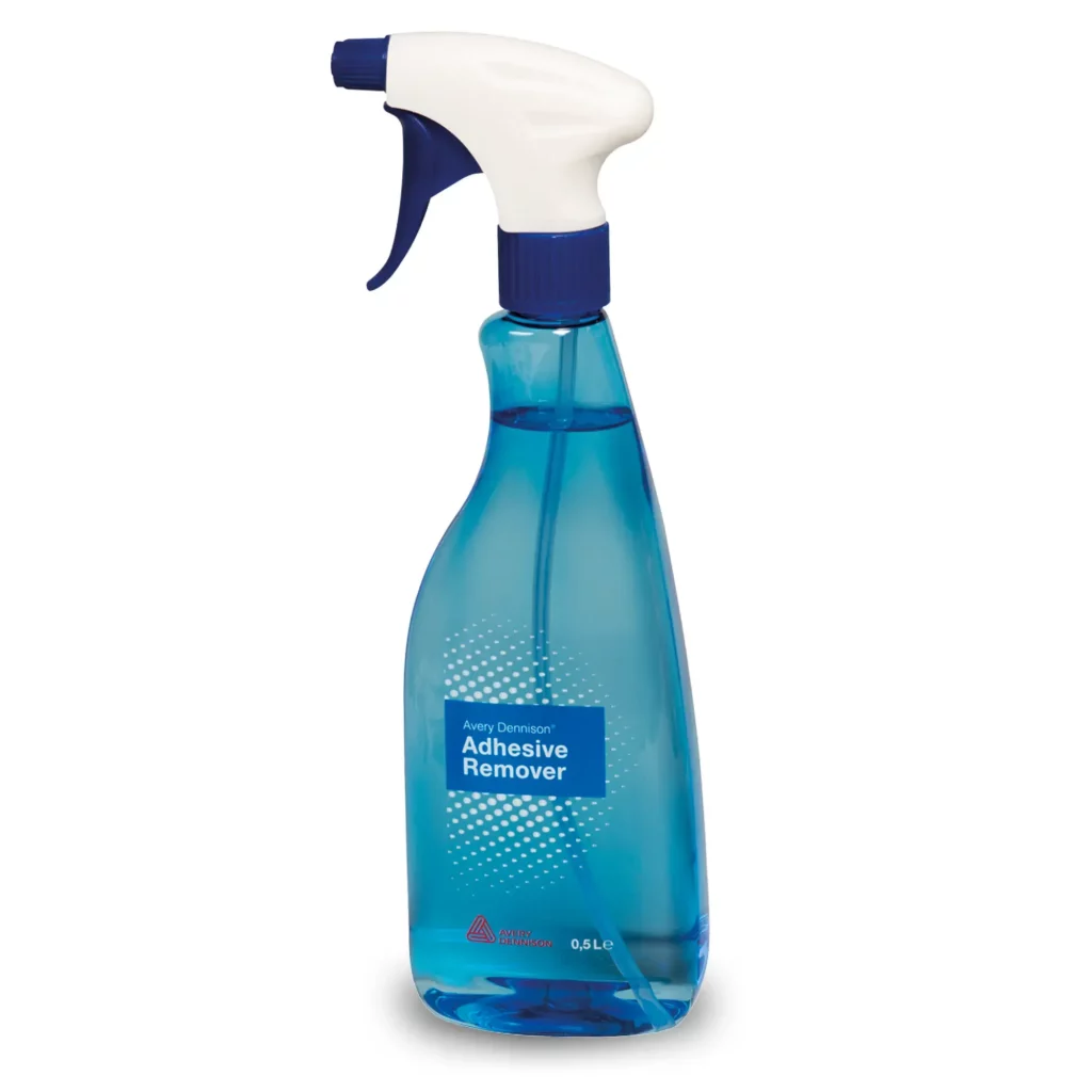 Avery Dennison Adhesive Remover fluid in it's 500ml, light blue teardrop-shaped bottle. The photo shows a side on view of the tear drop bottle-neck shape with a slight swan neck grip, complete with adjustable sprayer nozzle at the top and blue printed label with Avery Dennison branding facing towards the camera.