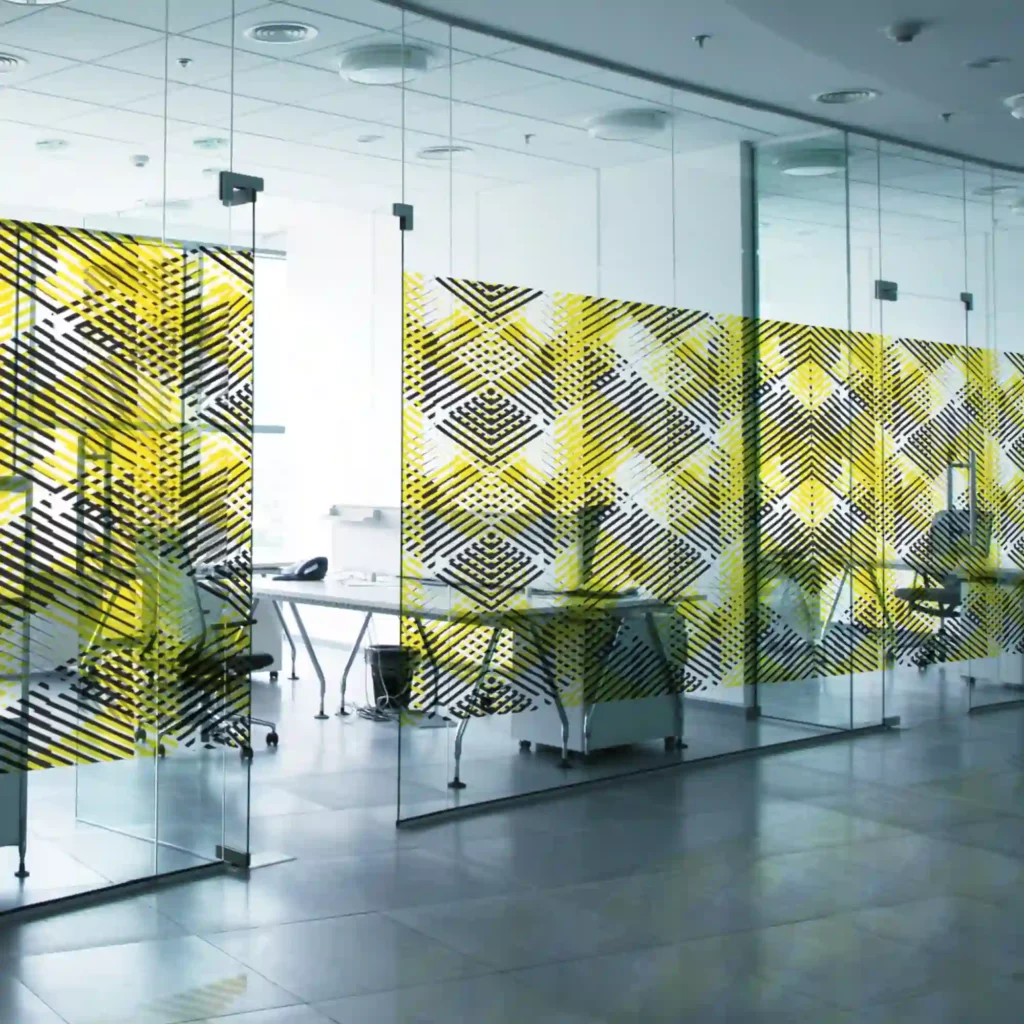 Avery Dennison SF100 ultra clear non-PVC print film, printed with a tasteful black and yellow hexagonal box-shaped series of lines that provide decorative window privacy for these glass partition office walls.