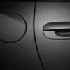 Avery Dennison SWF Extreme Texture Series from the Supreme Wrapping FIlms range includes this stunning brushed black effect self-adhesive vinyl which has been expertly wrapped into all of the intricate contours of the car, completley covering the door handle and peterol cap which are shown in close-up to reveal the fine brush pattern of the film and the colour change in detail, not to forget the flawless application to the vehicle surface!