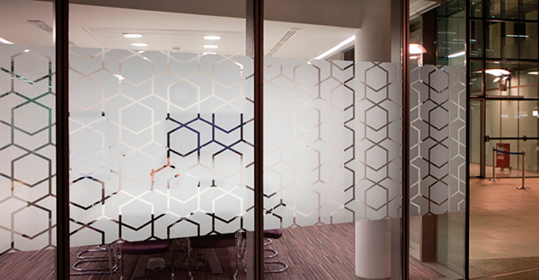 Avery Dennison Dusted glass effect window film with cut vinyl abstract shapes decorating the internal side of this meeting room offering privacy and a stylish window pattern to compliment the room decor.