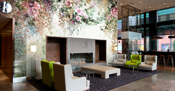 Avery Dennison MPI 8621 floral wall print vinyl printed with a floral design and applied to decorate the walls above and around this large open fireplace within a hotel bar setting.