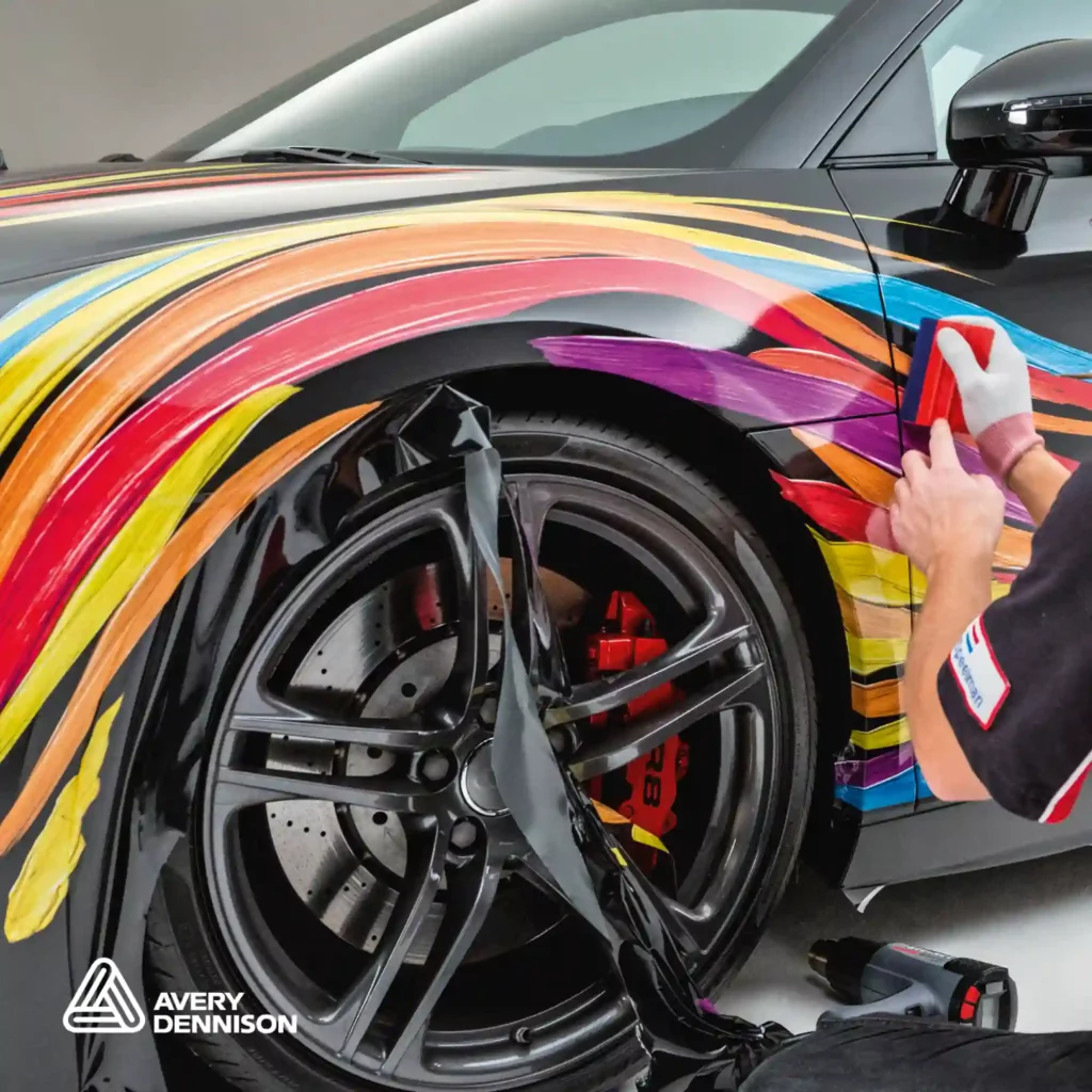 Avery Dennison MPI 1000 Series of long term print vinyls for wrapping projects are conformable cast films designed for complex and full 3D vinyl wraps as shown in this photo being applied to the intricate wheel arch contour details of this sports vehicle.