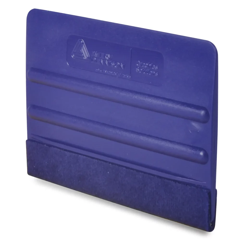 4 inch blue ribbed plastic squeegee with a blue felt covering over one edge and two central ribs for finger grip control and Avery Dennison logo branding on the side.