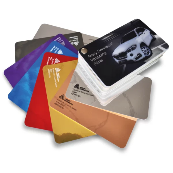 The Avery Dennison Wrapping Films swatch with the 8 Conform Chrome Series of metallic self-adhesive vinyl colour page samples fanned out, distinctly different from the rest of the colour pages inside the closed swatch block.