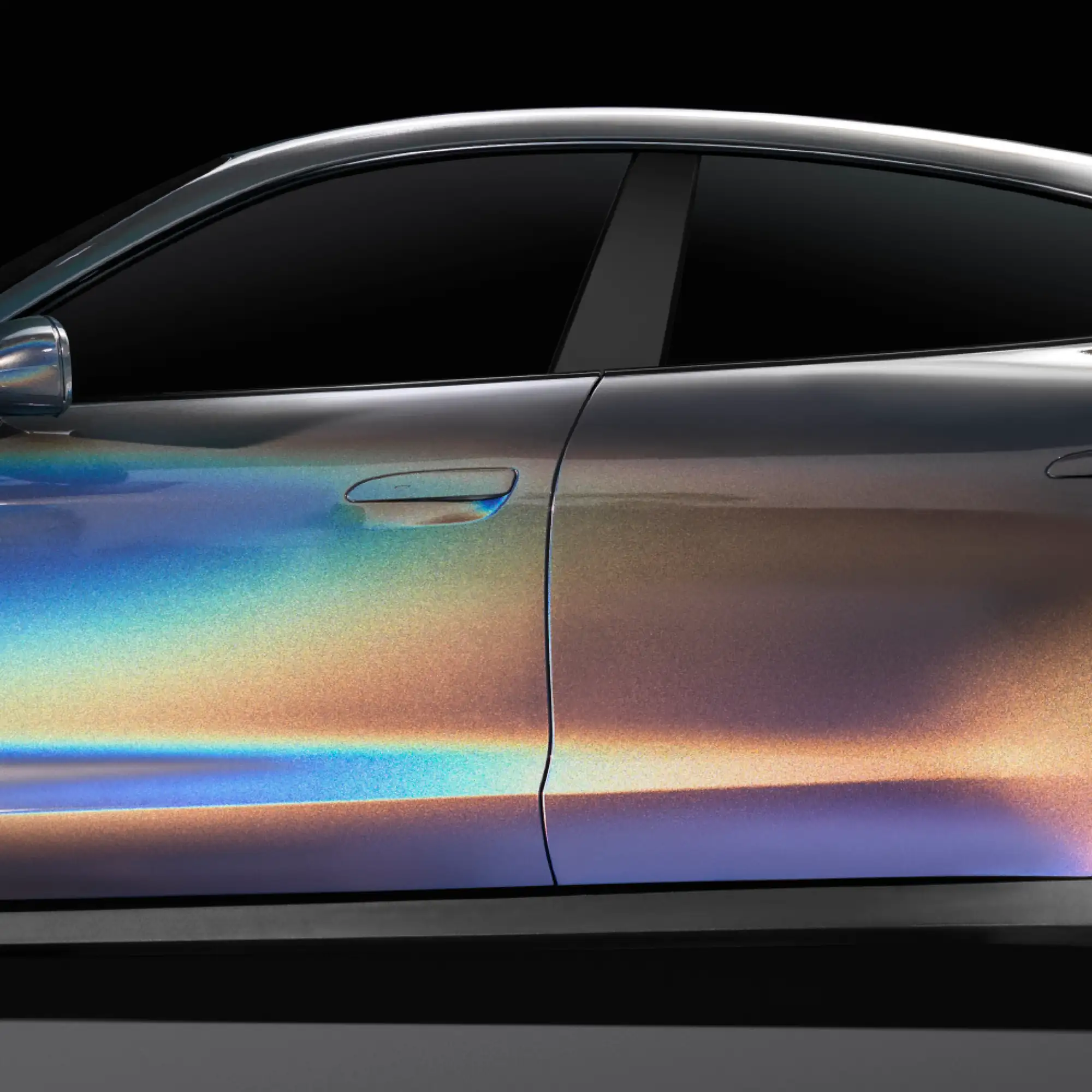 Avery SWF Colorflow car wrap vinyl in Moonstone Silver Iridescent colour covers the full body of this modern road car, with the photo really highlighting the colour-change aspect of the vinyl as you can see a spectrum of changing colours as the light reflects off different contours of the bodywork, ranging from silver, dark silver, through blues, purples and golds.