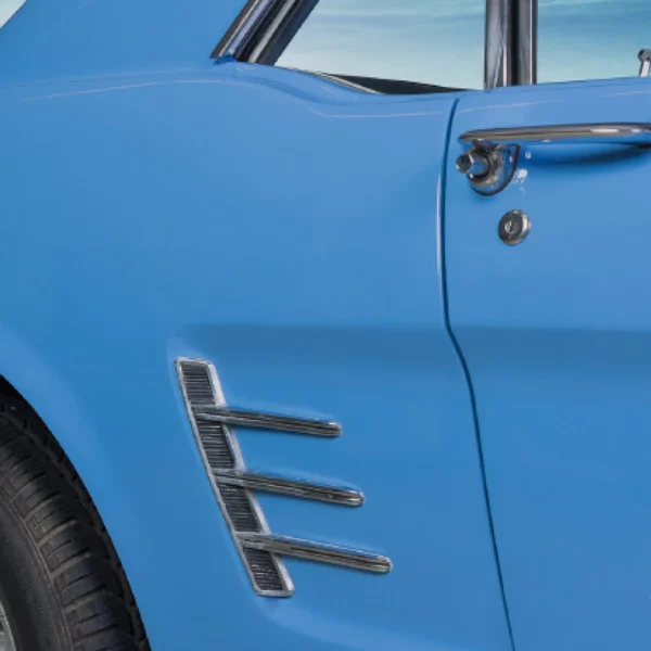 Avery Dennison SWF Solid Colour wrapping vinyls offer a choice of many colours, including this matt finished smokey blue vinyl colour which covers this classic car with the photo focussing on the beautiful detail of the cars contours and the chrome work on the door handle and rear-side air vent decoration, as well as the professional finished application of the self-adhesive film.
