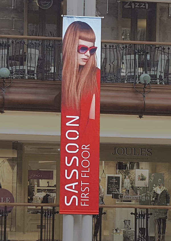 Krea Blackback Soft 1056-16 printed with brand advertising and suspended down a pillar within a large shopping centre, hanging down across multiple floors in the main shopping forecourt area.