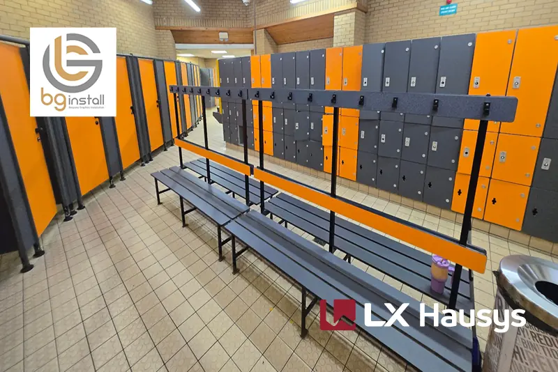 A case study where BG Install, based in Portsmouth, refurbished lockers, cubicles, toilets, and front-of-house areas using LX Hausys self-adhesive interior films to complete a stylish, sophisticated and modern refurbishment at Quays Leisure Centre, as illustrated perfectly in this photo of one of the finished locker rooms with all doors and cabinets beautifully wrapped in RS52, dark grey solid finish and RS191, orange to inject a bold pop of colour.
