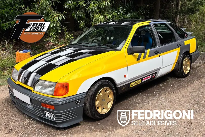 A case study of how Nathan Squire at Fullcircle created a full Fedrigoni wrap for his own classic Ford Sierra, featuring a period race design with a black and white chequered race flag for the bonnet and roof, with grey, yellow and white accented printed colours wrapped over the sides and doors to complete the transformation.