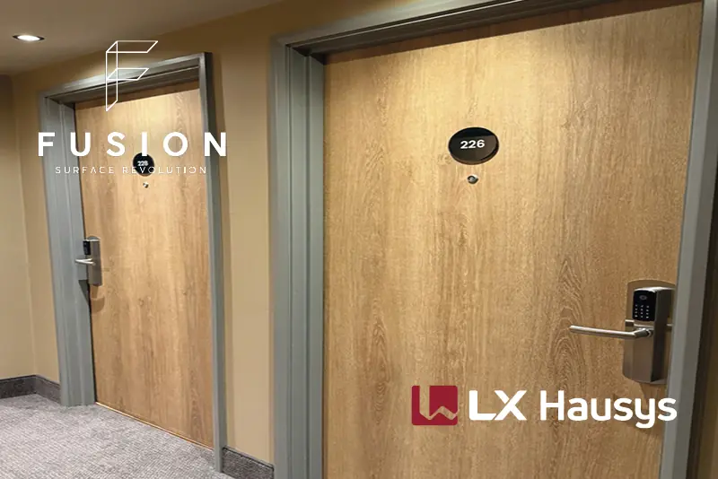 A view looking down a Hotel corrifdor, showing doors that have been beautifully refurbished with LX Hausys textured wood finish interior film, showing the realistic wood effect finish that not only looks stunning but also prevents perfectly good, solid, expensive doors from going to landfill, giving the doors a whole new lease of life!