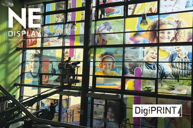 DS3054 P ultra clear window films have been printed with high-quality photos of people from the school and the self-adhesive prints are pictured in the process of being installed onto a huge set of large canteen windows, using ladders and cehrry pickers to reach the highest window panes.