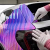 Cast vehicle wrapping laminate DOL 1360 Z and MPI 1103 Smart Wrap+ print vinyl vehicle wrap, with the film being carefully trimmed in the recessed area of the rear boot.