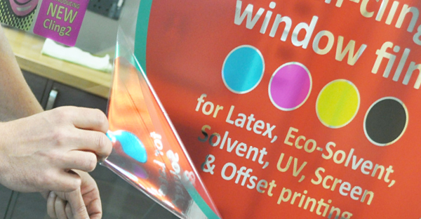 Cling2 static cling, non-adhesive window print vinyls are availble in either gloss clear or gloss white self-sling films. The photo here shows a printed internal window sign on the clear film being pulled away cleanly and easily from an internal window leaving no adhesive residue after being positioned and re-postioned on the window multiple times.