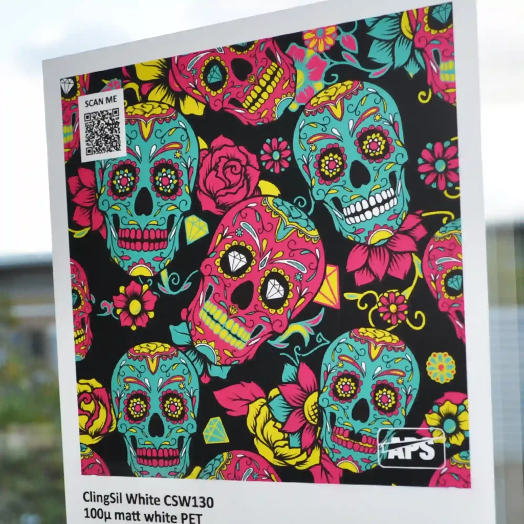 A digitally printed, matt white, window cling film, Digiprint ClingSil CSW130, featuring a bold, high-contrast skulls design. The graphic showcases multiple skull illustrations arranged in a visually striking pattern, intended for eye-catching window displays or promotional signage.