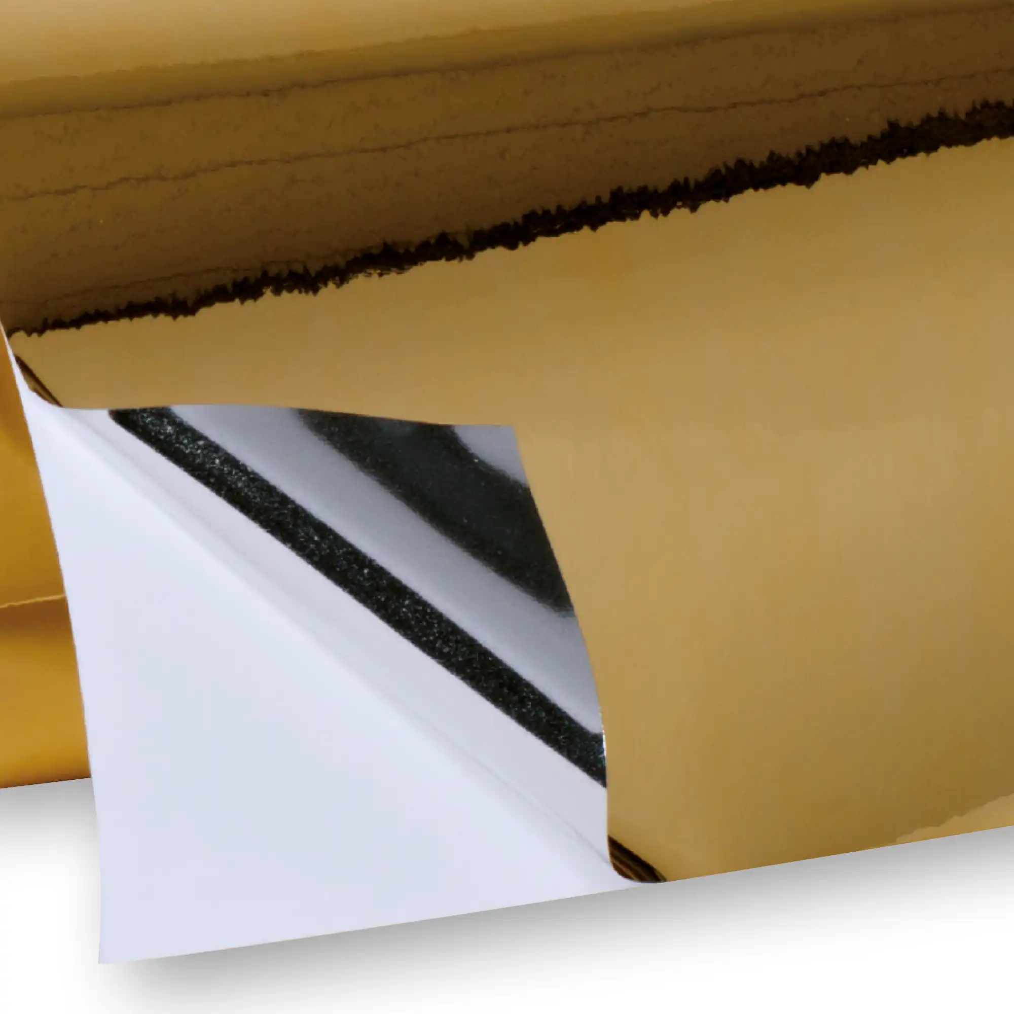DigiPRINT TSGG3 gloss gold one-way viewable metallised print film on a roll with one corner edge folded over to show the shiney silver colour back on the adhesive side of the film as it is pulled away from the liner.