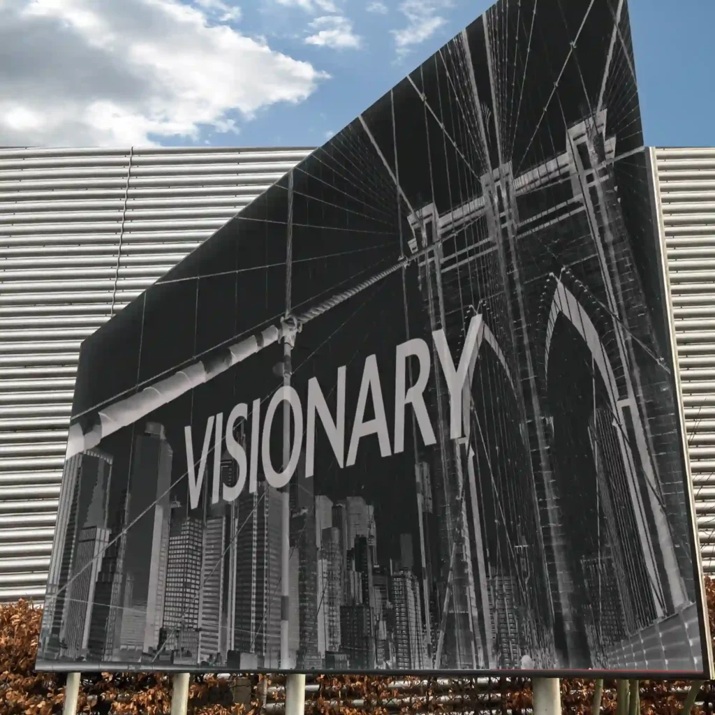 Striking black and white billboard advertisement printed on wide-format digital inkjet poster paper for outdoor signage, positioned at a busy roadside for maximum visual impact.