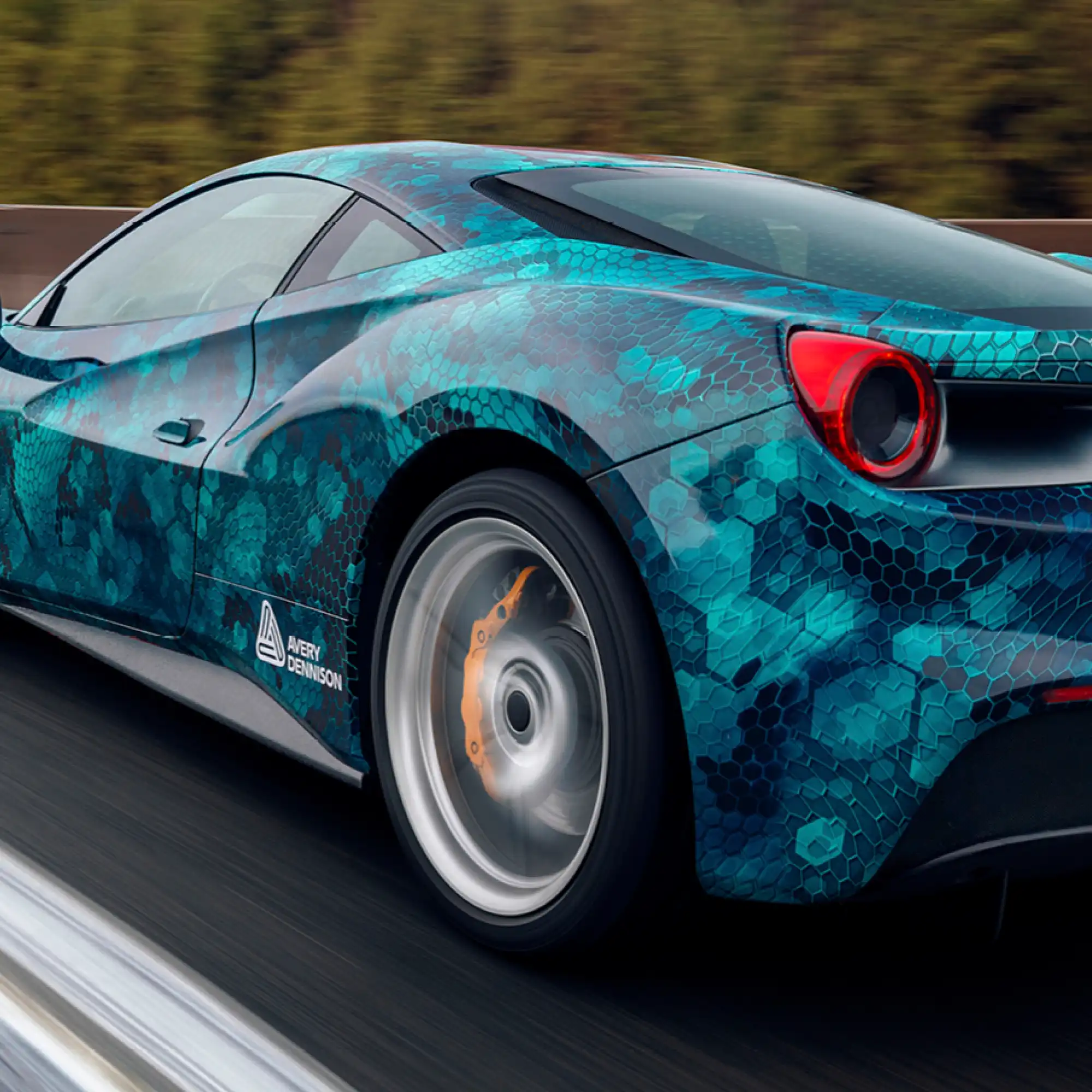 Avery Dennison DOL 1480 Z matt wrap laminate over printed sportscar graphics racing around a race track.