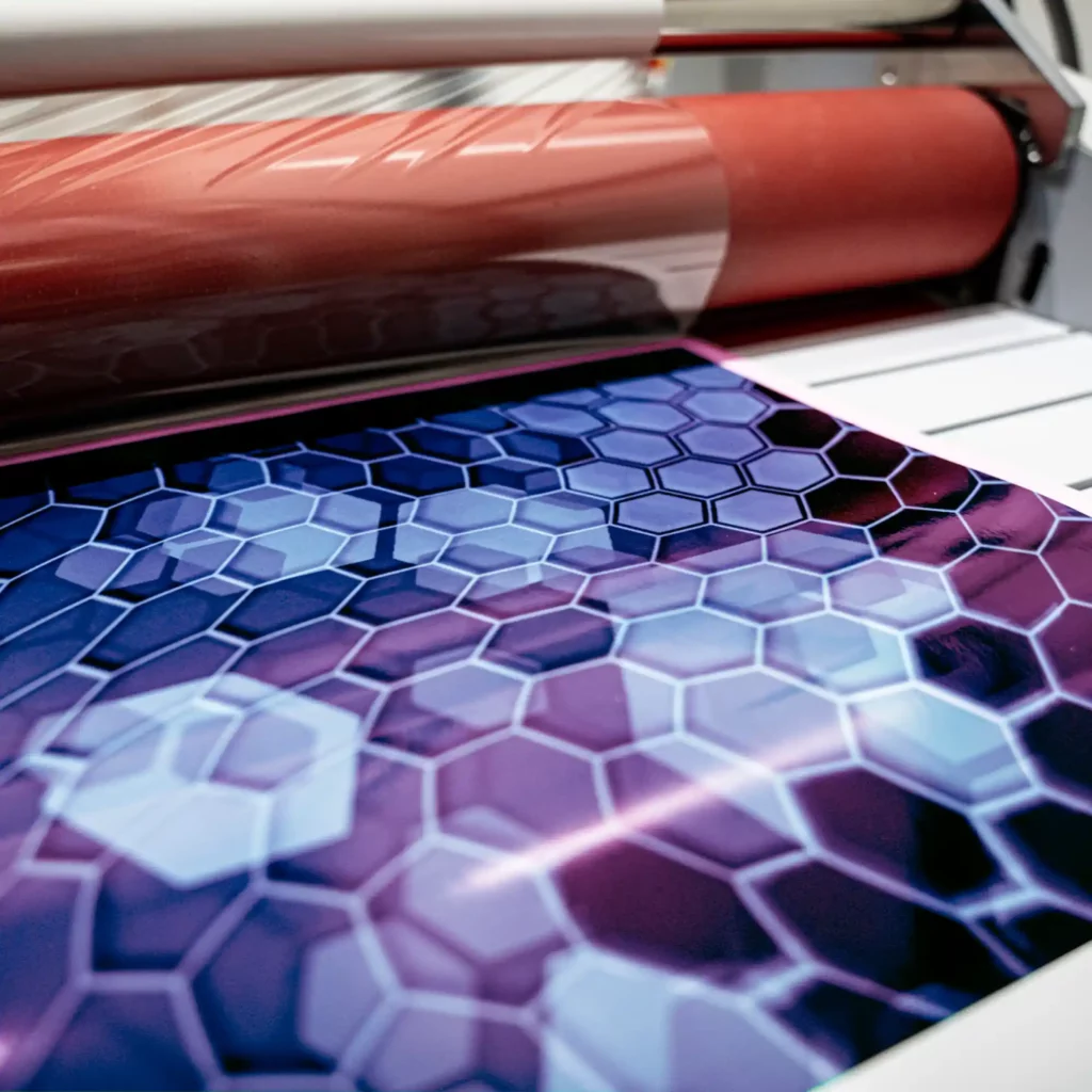Avery Dennison DOL 2460 fire rated, gloss digital print laminating film pictured during the process of applying the glossy graphics laminate onto a large format printed image.