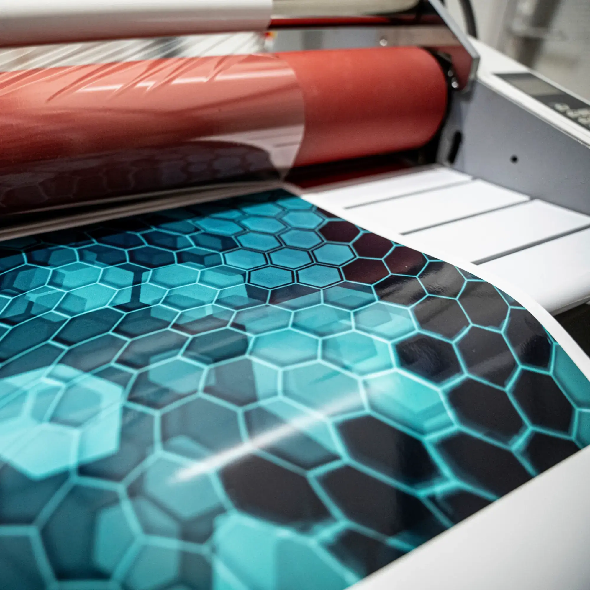 Avery Dennison DOL 6560 High Gloss PU polyurethane laminate overlaminating a printed blue / green geometric style wrap graphic.