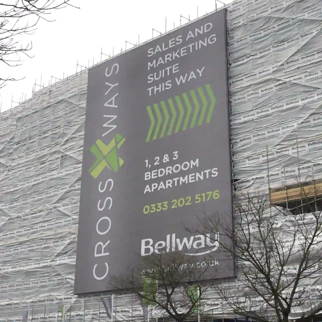 EF500 ultra-large format printed construction site banner attached to the side of a large city development site, offering the dual-purpose opportunity for high-impact outdoor advertising and to shield the public from unsightly scaffolding and other on-site works that are in progress.