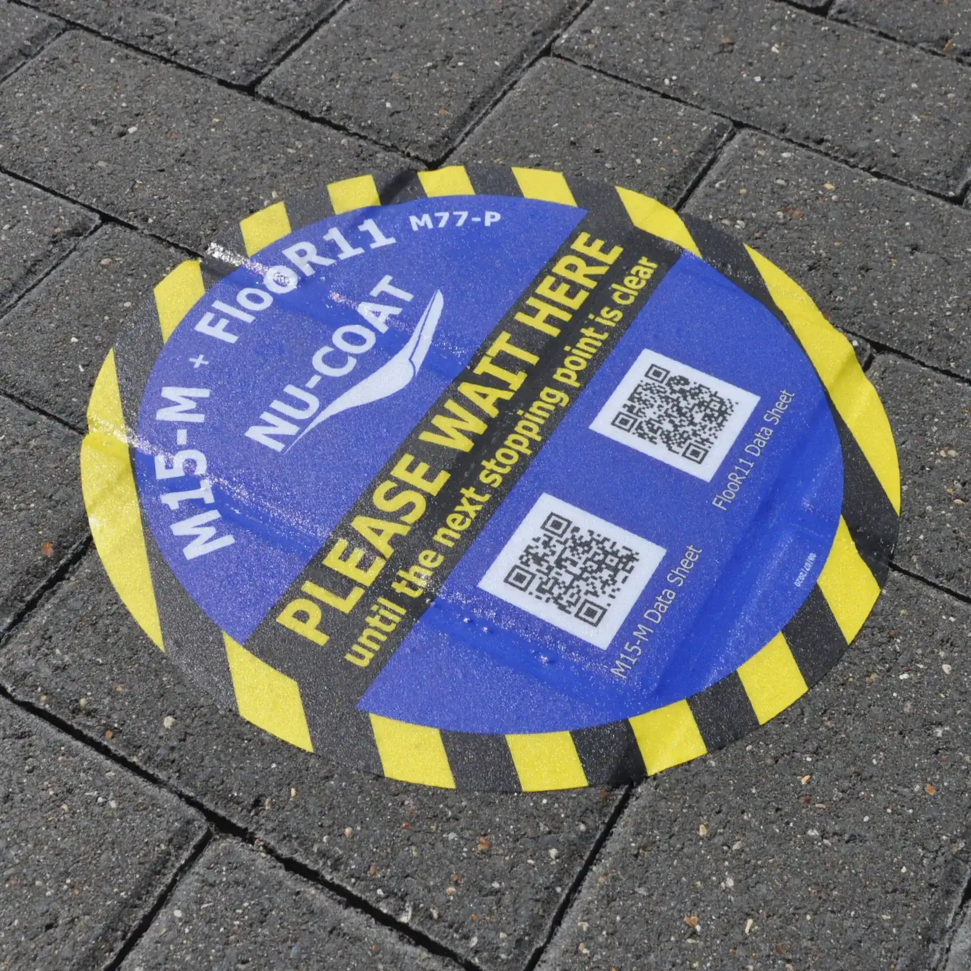 R11 slip rated flooring laminate, M77-P has been laminated to M15-M floor print vinyl and applied to external block paving. Photo detail shows the vinyl confirmed into the recesses between the flooring bricks.