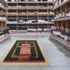 FloorSharK one part internal floor graphic solution printed with 'wine is always a good idea" text and applied to the floor in the middle of the wine section aisle of an off-licence / supermarket.