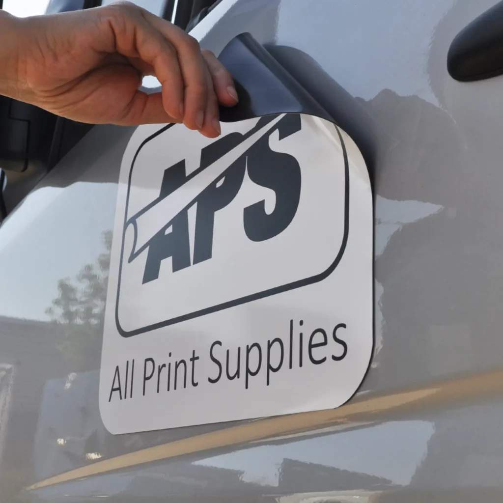 Gloss White Magnetic temporary signage vinyl with APS logo branding applied in the shape of self-adhesive cut-vinyl applied to the magnetic replaceable and removable film that magnetically sticks to most metallic surfaces, most often found on cars and vans but also used on temporary/moveable labels, promotional magnet products and more.