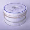20mm and 50mm width 'Hook & Loop' tape reels placed on top of eachother in a pile with the white reel packaging marked to show the designation of each product size and type of sign tape inside the wheel.