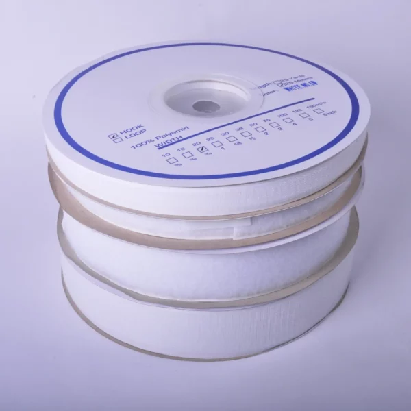 20mm and 50mm width 'Hook & Loop' tape reels placed on top of eachother in a pile with the white reel packaging marked to show the designation of each product size and type of sign tape inside the wheel.