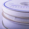 A closer look at the Hook and Loop tapes wound into their own individual reels in white printed wheel packaging and stacked one on top of the other. 20mm and 50mm width reels are shown with the narrower widths of tape on top.