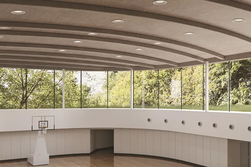 Interior decor vinyls decorate the walls and ceilings of this indoor sports hall, with white and cream self-adhesive interior films around the walls of the basketball court and on the ceiling a complimentary wood finish that brings light and warmth to the whole arena.