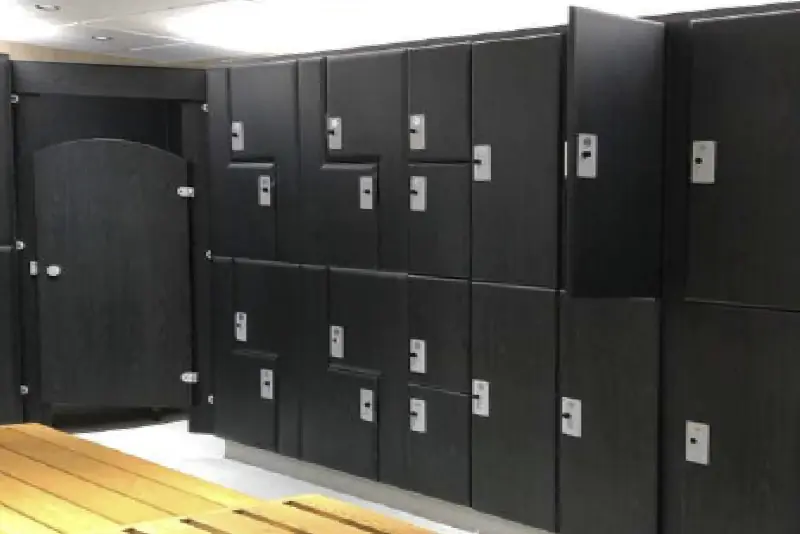 Black Oak wood interior film applied to the surfaces of locker room cabinets to decorate, uplift and refurbish the previous old, worn interior surfaces.