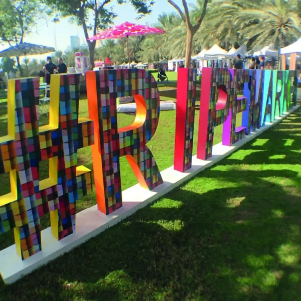 JT 8500 WG-PG fire rated print vinyl, printed with vibrant coloured abstract block patterns and applied to large 3D letters asn a short term art installation.