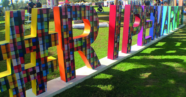 JT 8500 WG-PG printed with vibrant coloured abstract block patterns and applied to large 3D letters asn a short term art installation.