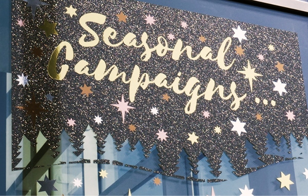 K75150 Black Glitter used as a cut-graphic background for a Seasonal window sign advert - the glistenining effect of this black vinyl is really punchy especially as the sun hits it and it sprakles, really bringing the window sign to life!