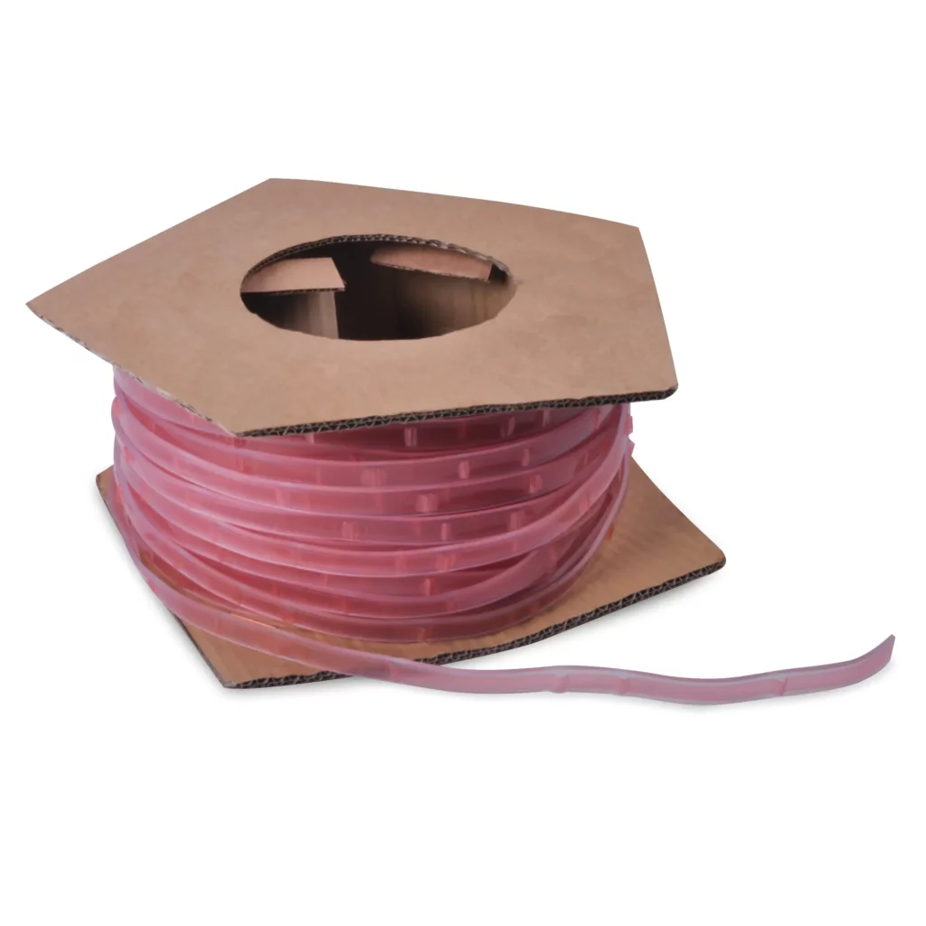 Self-Adhesive Keder PVC tape used for fabric framing systems is pistured in it's cardboard drum packaging, with the textile tapes distinct red coloured protective adhesive liner facing outwards.